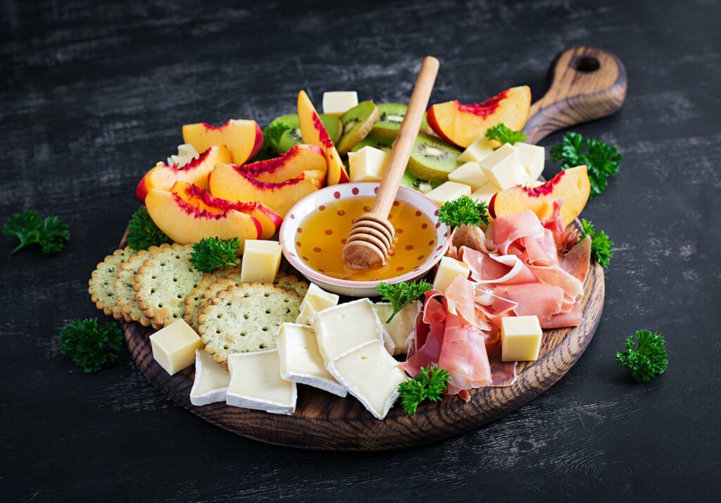 Italian antipasto catering platter with prosciutto, cheese and fruit